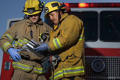 Two Firefighters Checking A Property S Layout Thumb 